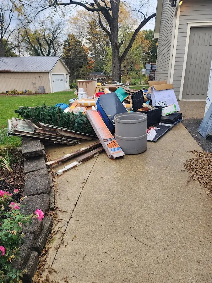Dumpster being loaded with debris for Roofing Dumpster Rental in Leoni